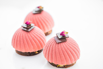 Three pink cupcake background on white