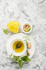 Ingredients for homemade lemon sauce vinaigrette dressing for salad with olive oil, salt, pepper,...