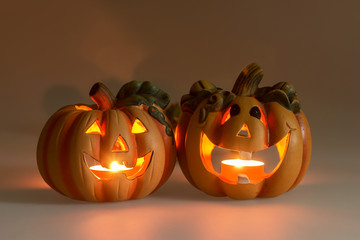 Two Halloween pumpkins head jack lantern with burning candles