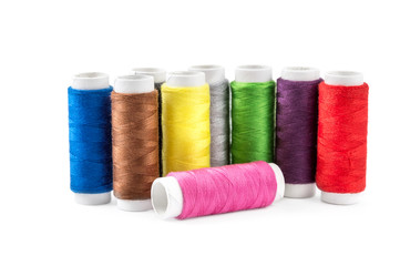 Colored sewing threads on white.