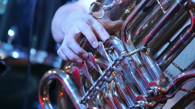 Man plays on the tuba melody on concert