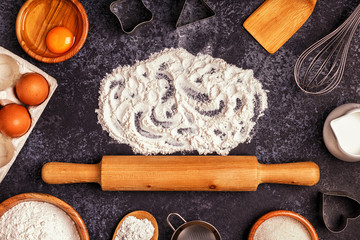 Ingredients for baking  - flour, wooden spoon, rolling pin, eggs
