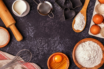 Fototapeta na wymiar Ingredients for baking - flour, wooden spoon, rolling pin, eggs