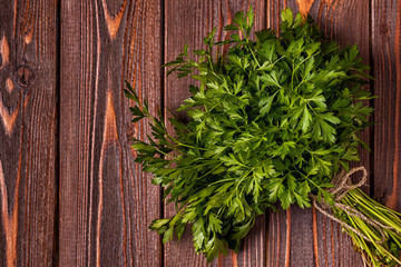 Bunch of parsley  on a wooden background.