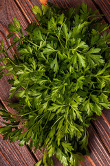 Bunch of parsley  on a wooden background.