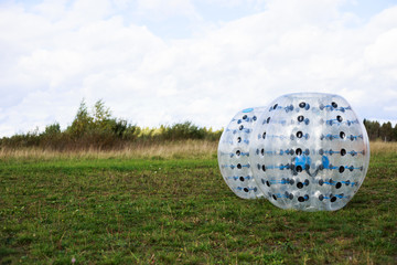Bumper-balls for soccer playing on a green lawn, a new funsport