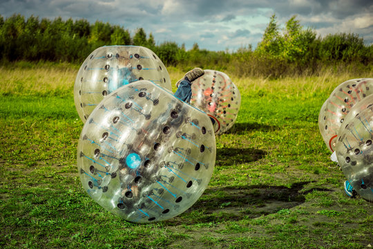 Bumperball. Teens play bumper-ball outdoor