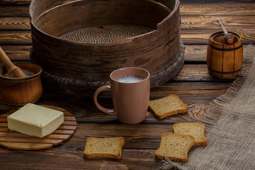 Butter toast, honey and milk on wood backgraund.