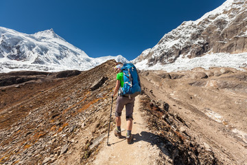 Hiker is climbig to Manaslu base camp in highlands of Himalayas on Manaslu circuit