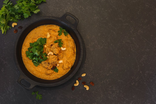 Spicy Mutton  Korma With Cashew Nuts And Coriander Leaves. Top View With Blank Space On Right Side