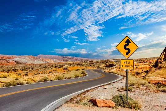 Naklejki Road Sign for Curves in Desert