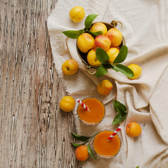 Fresh apricot juice in glass on wooden table, selective focus