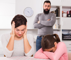 Father lecturing wife and daughter