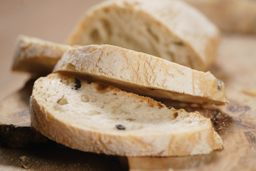 closeup slices of ciabatta on wood board