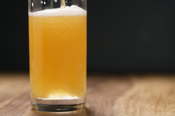 wheat unfiltered beer poured into glass on wood board