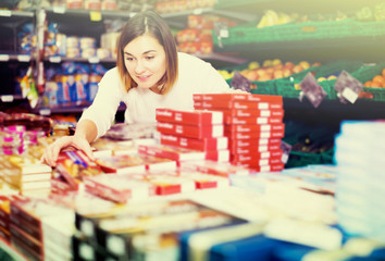 Fototapeta premium Female shopper searching for sweets