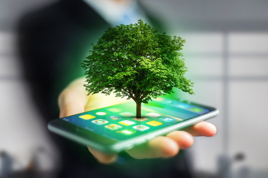 Green tree going out of a smartphone - Ecology concept