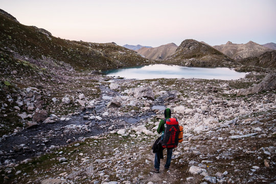 Man with big backpack trakking on the mountains