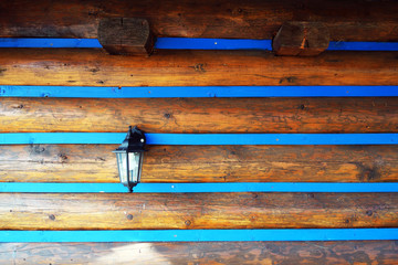 Electric lamp on a wooden wall