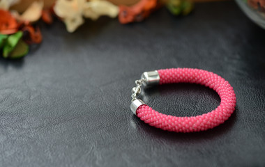 Bead crochet bracelet red color on a dark background