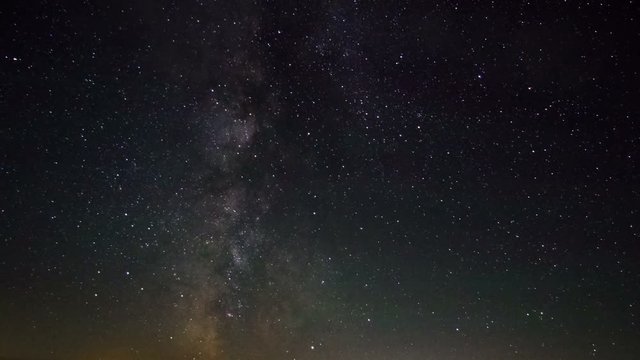 Milky Way Galaxy astronomy time lapse stars moving above mountain valley light pollution near horizon bright night campsite summer view of milkyway move across sky science space universe presentation