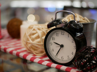 lantern candle and alarm clock with red and white fabric artificial flowers bouquet home decoration concept on bokeh background