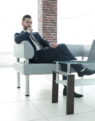businessman sitting at a coffee table in the lobby