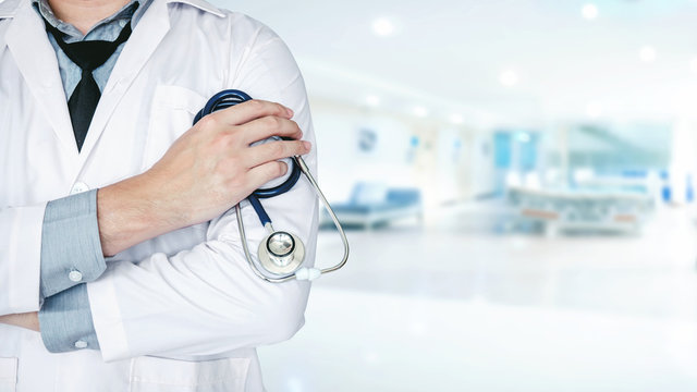 Doctor holding a stethoscope on background of Hospital ward