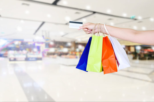 Woman holding shopping bag and Credit card in Shopping mall