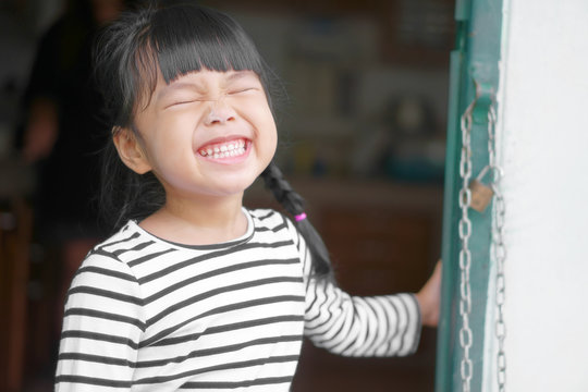 Asian Children Cute Or Kid Girl Laugh And Smile White Teeth With Powder Mess Up On Face For Enjoy And Fun At Home Door With Space