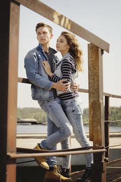 Young beautiful fashion couple wearing jeans clothes in daylight