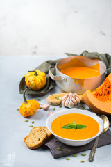 Fall autumn roasted orange pumpkin carrot soup with garlic