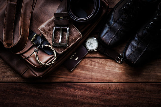 Men's leather accessories and passport on rustic wooden background, fashion and beauty, travel concept