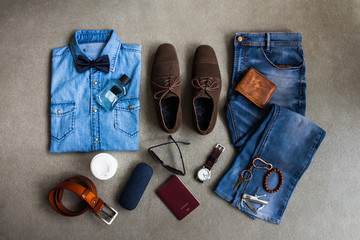 Men's casual clothes outfits with jeans, leather shoes and accessories on gray background