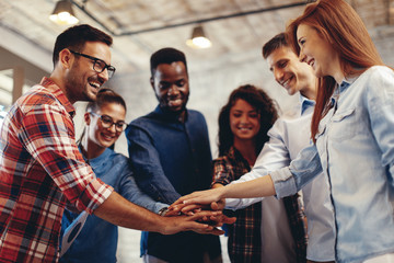 Young people showing team spirit focus on hands