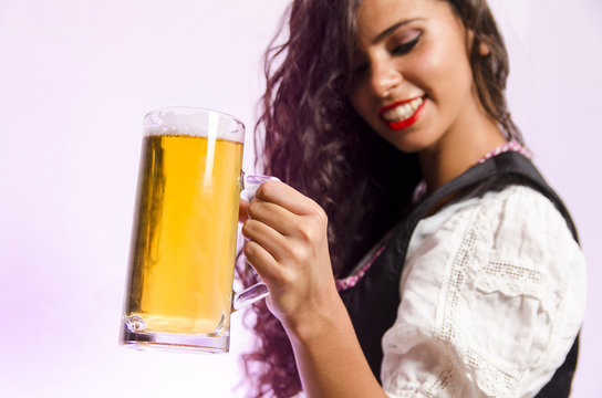 Closeup, gorgeous woman with beer mug, selective focus on beer