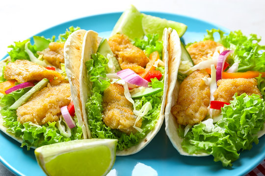 Plate with tasty fish tacos, closeup