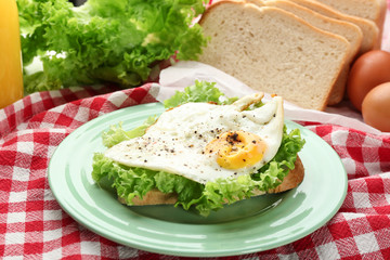 Plate with delicious breakfast on table