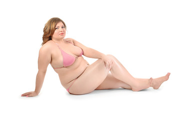Fototapeta na wymiar Overweight woman in swimsuit posing on white background