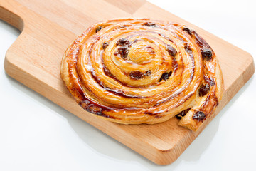 Fresh homemade pain au raisins over wooden background.