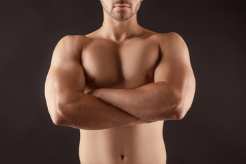 Fototapeta premium Sporty young man on dark background