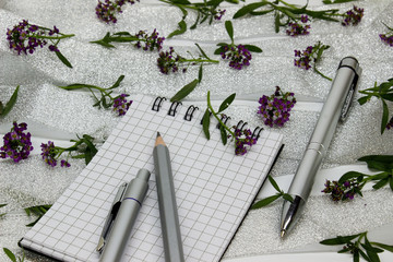 stationery on small purple flowers and silver ribbon
