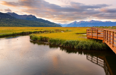 Fototapeta premium Beautiful sunrise at Potter Marsh Wildlife Viewing Boardwalk, Anchorage, Alaska. Potter Marsh is located at the southern end of the Anchorage Coastal Wildlife Refuge.