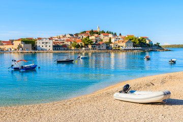Obraz premium Dingy boat on idyllic beach in Primosten town, Dalmatia, Croatia