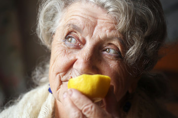 Elderly woman with lemon
