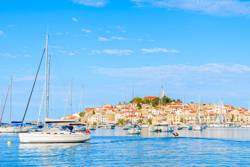 Fototapeta na wymiar Sailboats on sea water in Primosten town, Dalmatia, Croatia