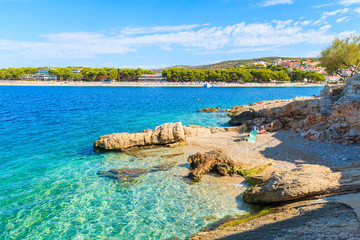 Small beach with rocks and turquoise sea water in Primosten town, Dalmatia, Croatia