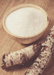 Xylitol - sugar substitute. Birch sugar on wooden background.
