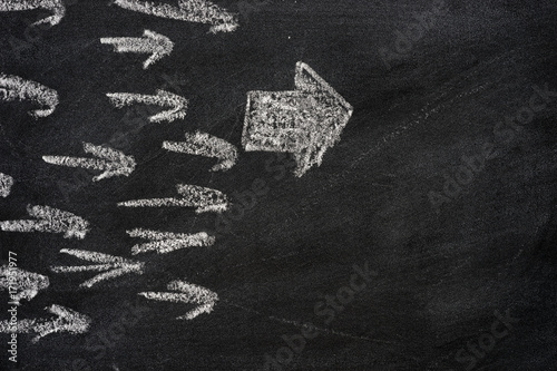 leadership arrow on chalkboard background stock photo and royalty