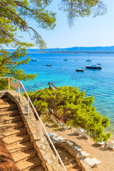 Naklejka premium Steps to wonderful beach with turquoise sea water in Bol town, Brac island, Croatia